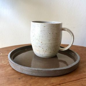 light grey cup on dark grey plate